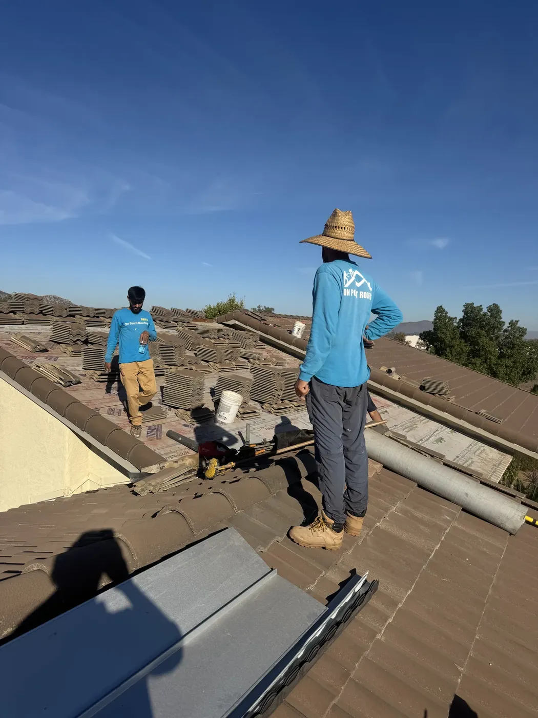 Roofing crew completing tile roof repairs on a home in Wildomar, CA