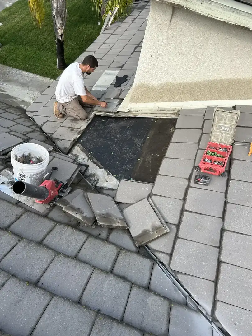 Roof repair work in progress on a Riverside County tile roof