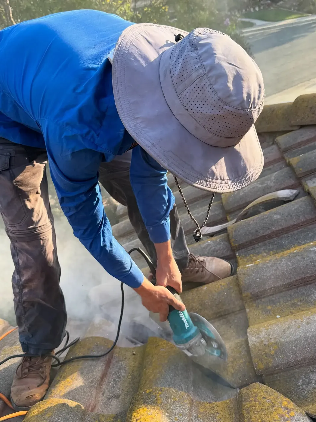Tile roofing specialist sealing roof tiles on a Temecula, CA home