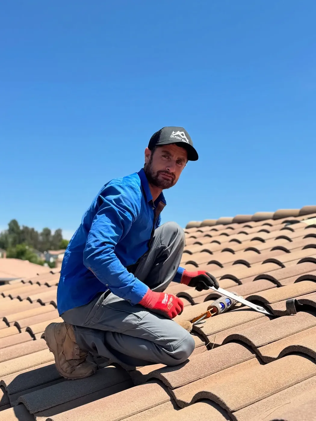 Roofer replacing broken roof tiles on a Wildomar, CA home